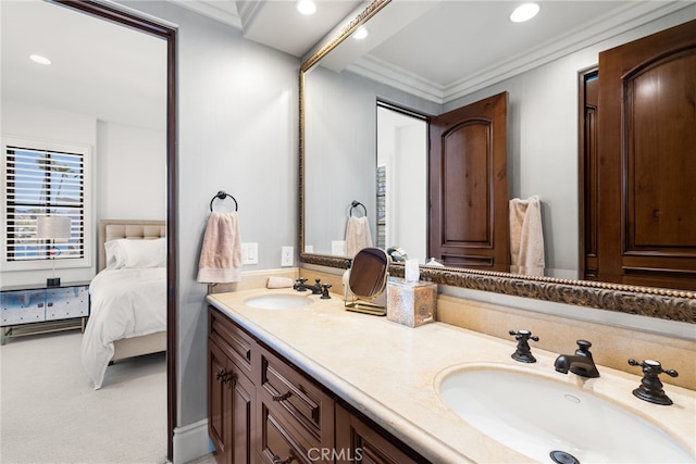 bathroom with ornamental molding, a sink, double vanity, and recessed lighting