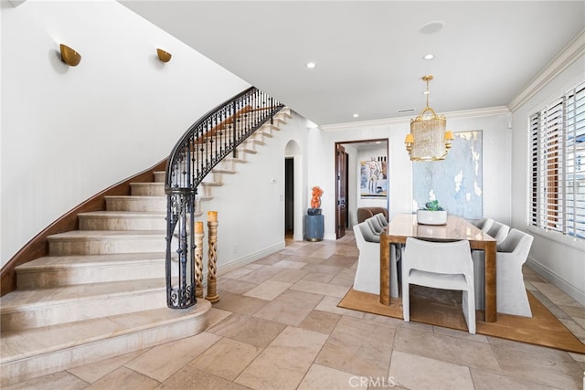 unfurnished dining area with baseboards, arched walkways, ornamental molding, stairs, and recessed lighting