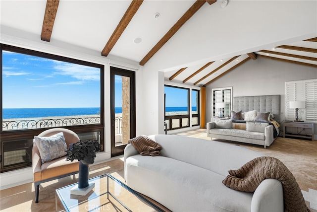 carpeted bedroom featuring access to exterior, a water view, a glass covered fireplace, high vaulted ceiling, and beamed ceiling