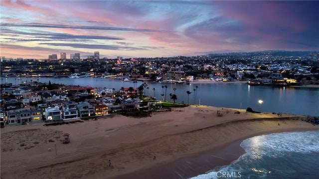 aerial view with a water view, a view of city, and a beach view