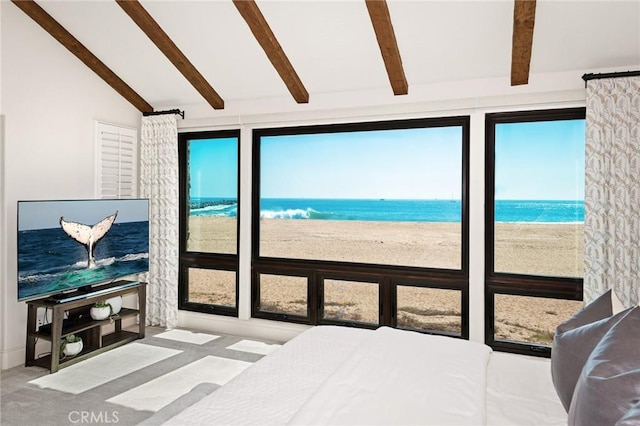 bedroom with a water view, a beach view, lofted ceiling with beams, and carpet flooring