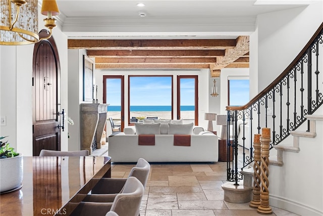 entrance foyer featuring crown molding, stone tile floors, beamed ceiling, baseboards, and stairs