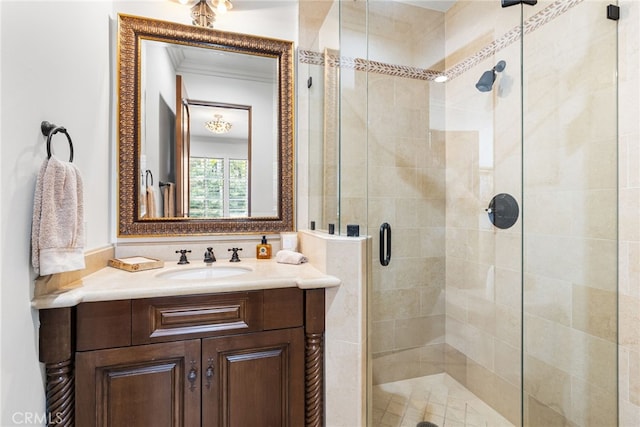 bathroom with ornamental molding, a stall shower, and vanity