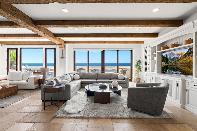 living room featuring beam ceiling, stone tile flooring, and recessed lighting