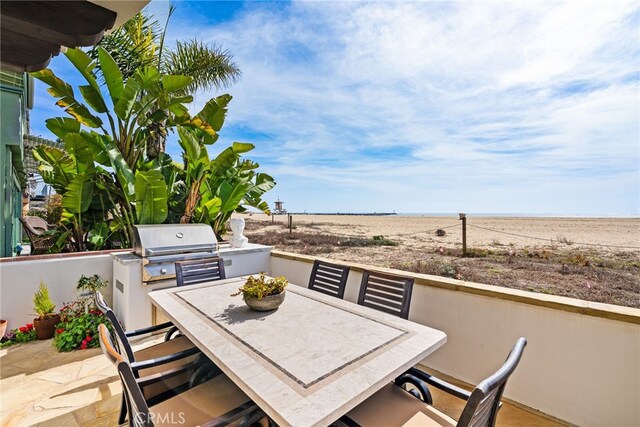 view of patio with outdoor dining area and area for grilling