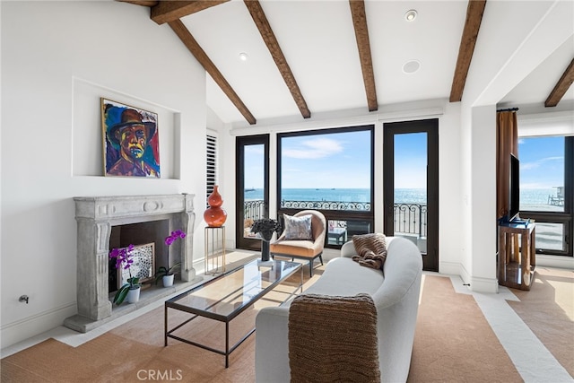 living area with light carpet, baseboards, beamed ceiling, high vaulted ceiling, and a high end fireplace