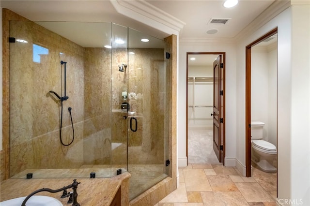 full bath with toilet, visible vents, a spacious closet, a stall shower, and crown molding