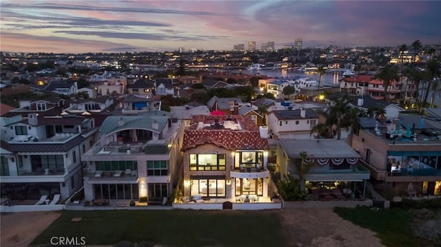 aerial view at dusk featuring a residential view