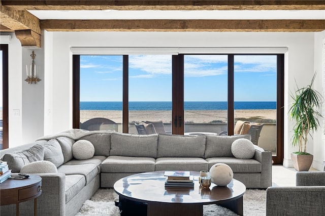 living room featuring a water view and beamed ceiling