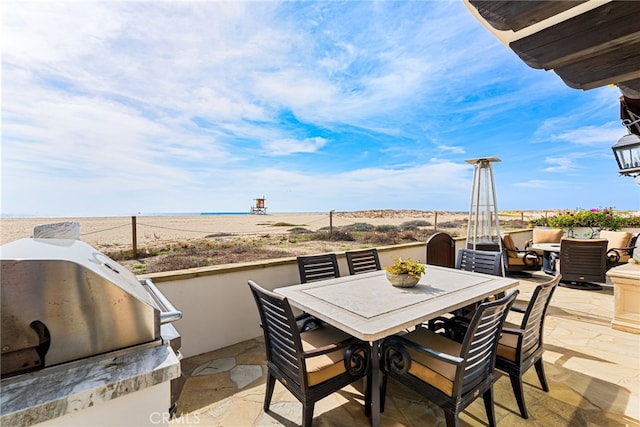 view of patio / terrace featuring outdoor dining area, area for grilling, and a water view