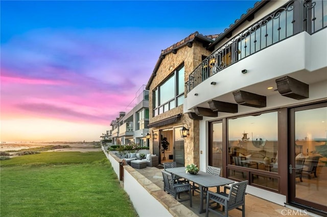 view of home's community with a patio area and a yard