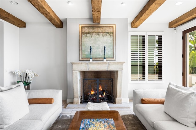 living room featuring beamed ceiling, a fireplace, and recessed lighting