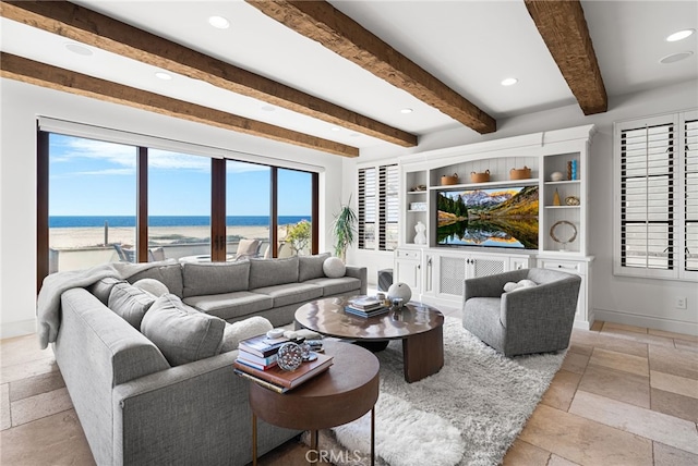 living area with recessed lighting, stone tile flooring, beam ceiling, and baseboards