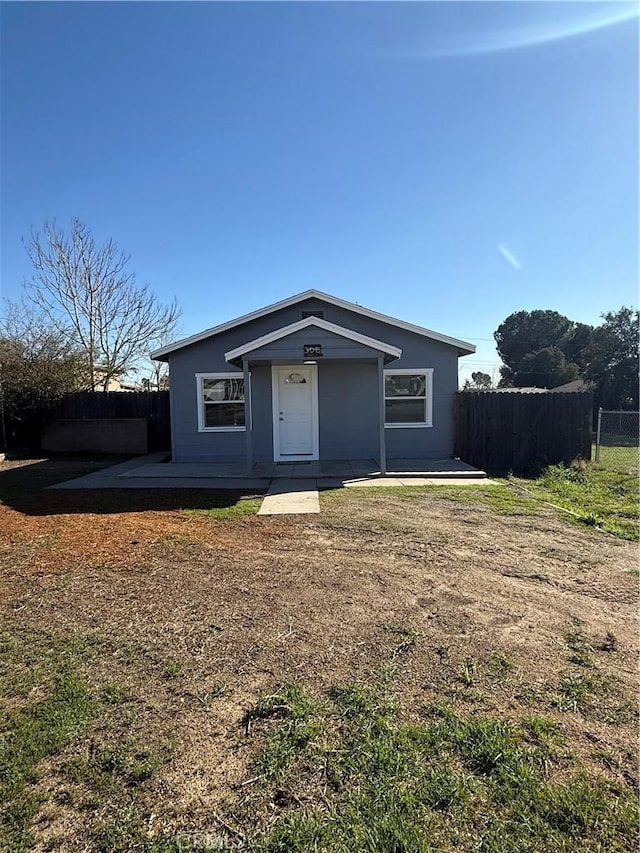 view of front of property with a patio and fence