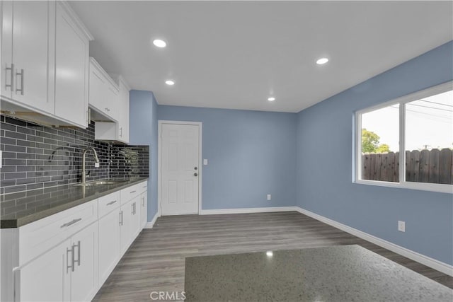 34945 Ave B, Yucaipa, CA 92399 - kitchen with a sink, baseboards, backsplash, and wood finished floors