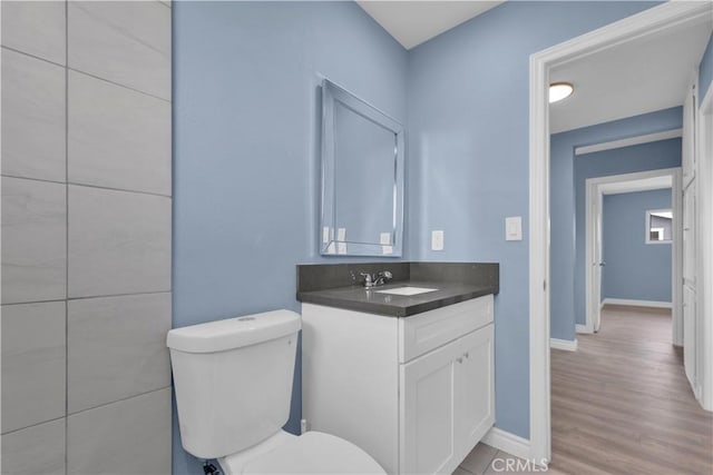 34945 Ave B, Yucaipa, CA 92399 - bathroom with toilet, baseboards, wood finished floors, and vanity
