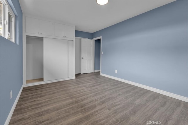 34945 Ave B, Yucaipa, CA 92399 - unfurnished bedroom with baseboards, wood finished floors, and a closet