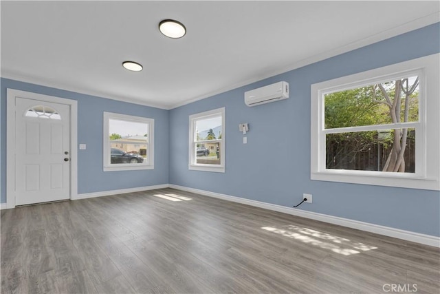 34945 Ave B, Yucaipa, CA 92399 - foyer featuring baseboards, a wall mounted AC, a healthy amount of sunlight, and wood finished floors