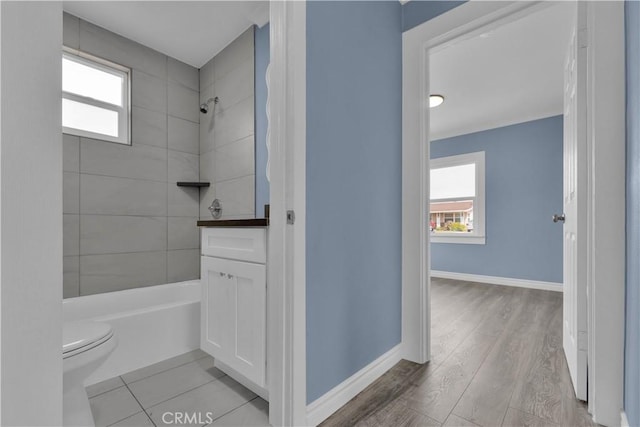 34945 Ave B, Yucaipa, CA 92399 - bathroom featuring baseboards, wood finished floors, bathing tub / shower combination, and toilet