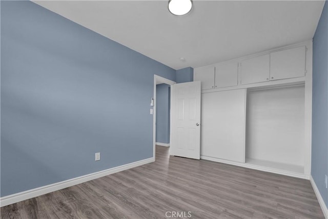 34945 Ave B, Yucaipa, CA 92399 - unfurnished bedroom featuring baseboards, wood finished floors, and a closet