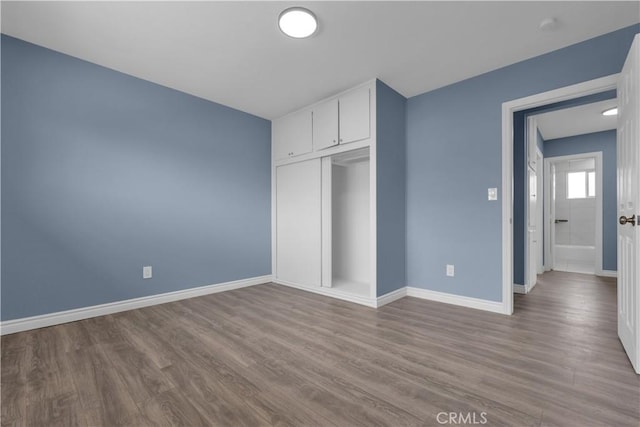 34945 Ave B, Yucaipa, CA 92399 - unfurnished bedroom featuring baseboards, wood finished floors, and a closet