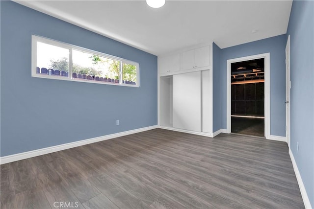 34945 Ave B, Yucaipa, CA 92399 - unfurnished bedroom with a closet, dark wood finished floors, and baseboards