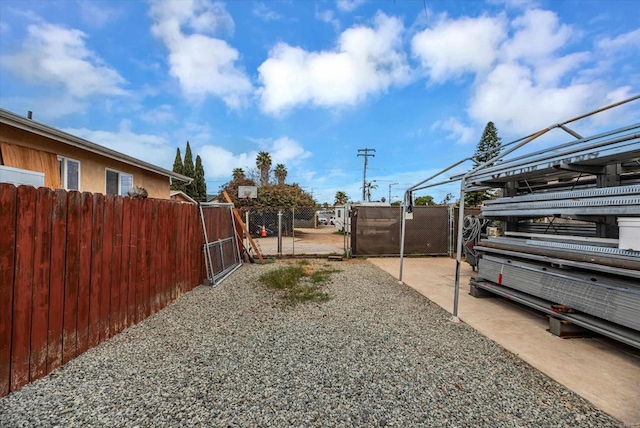 view of yard with fence and a gate