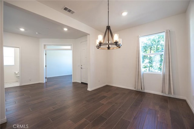 unfurnished dining area featuring baseboards, dark wood-type flooring, visible vents, and recessed lighting