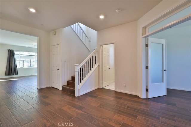 stairs with recessed lighting, baseboards, and wood finished floors