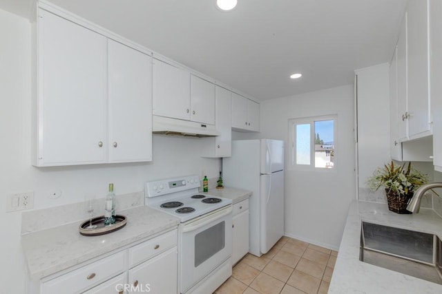 kitchen with white appliances, white cabinets, under cabinet range hood, a sink, and light tile patterned flooring