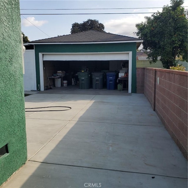 detached garage featuring fence