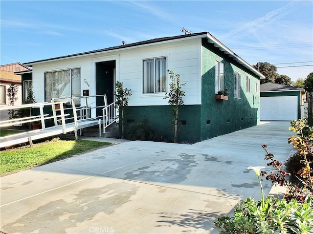 view of front of house with a garage, crawl space, an outdoor structure, and stucco siding