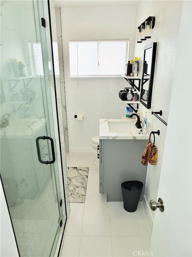 full bathroom featuring vanity, a marble finish shower, toilet, and baseboards