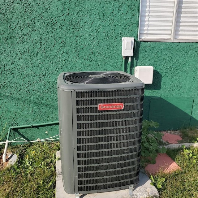 details featuring stucco siding and central air condition unit