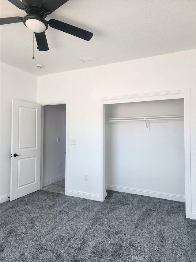 unfurnished bedroom featuring carpet flooring, a ceiling fan, baseboards, and a closet