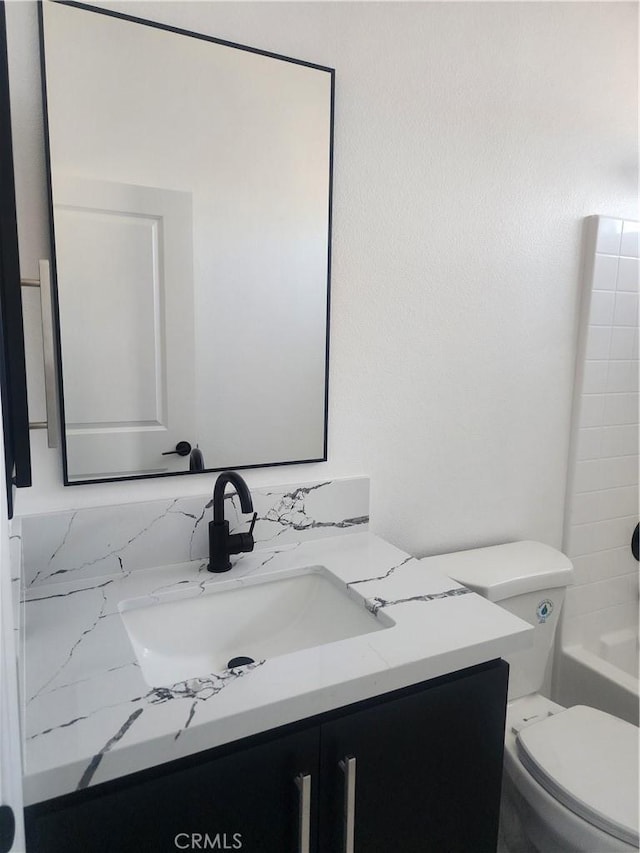 full bath featuring bathing tub / shower combination, toilet, and vanity