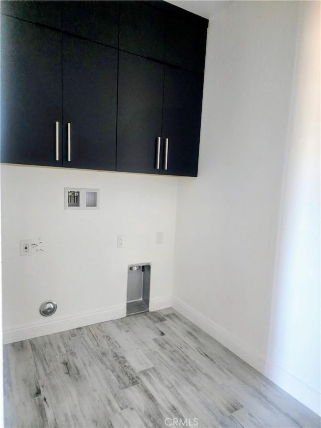 clothes washing area with electric dryer hookup, light wood-type flooring, baseboards, cabinet space, and hookup for a washing machine