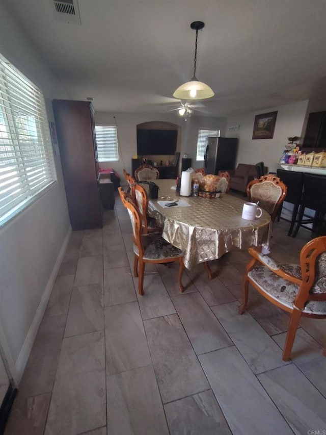 dining space featuring marble finish floor, a ceiling fan, visible vents, and baseboards