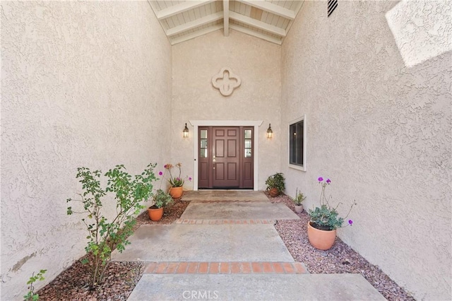 entrance to property featuring stucco siding