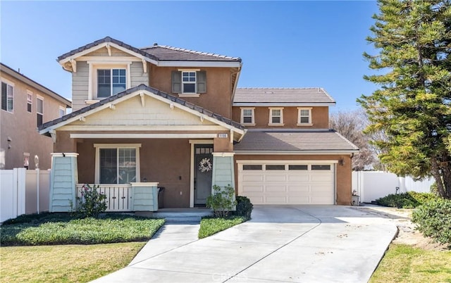 view of front facade with an attached garage, covered porch, fence, driveway, and a tiled roof