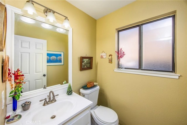 bathroom featuring vanity and toilet