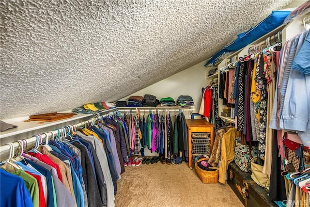 spacious closet featuring carpet floors and lofted ceiling