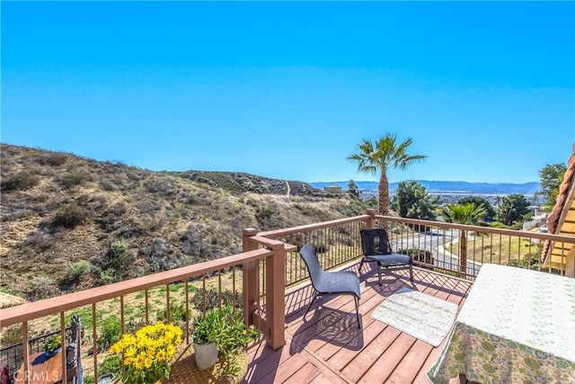 wooden deck with a mountain view