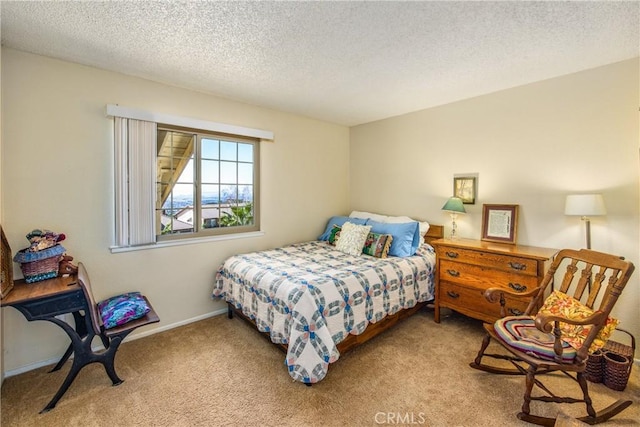 carpeted bedroom featuring a textured ceiling and baseboards