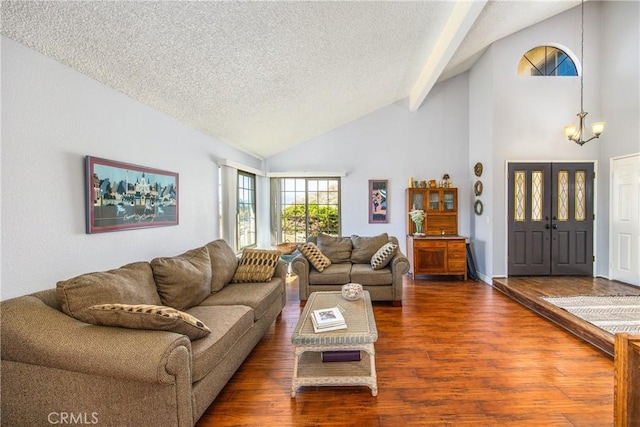 living room featuring a textured ceiling, high vaulted ceiling, wood finished floors, beamed ceiling, and an inviting chandelier