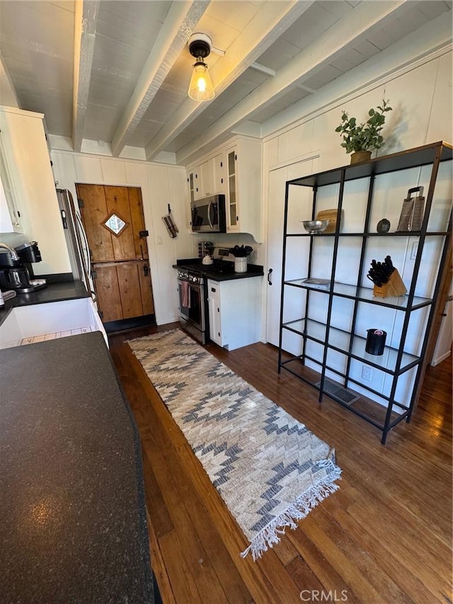283 Walnut Dr, Lake Arrowhead, CA 92352 - kitchen featuring stainless steel appliances, a sink, dark wood-style flooring, beam ceiling, and white cabinets