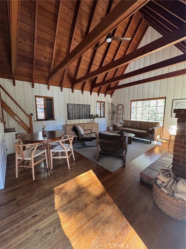 living room featuring wood-type flooring, wooden ceiling, beam ceiling, and stairs