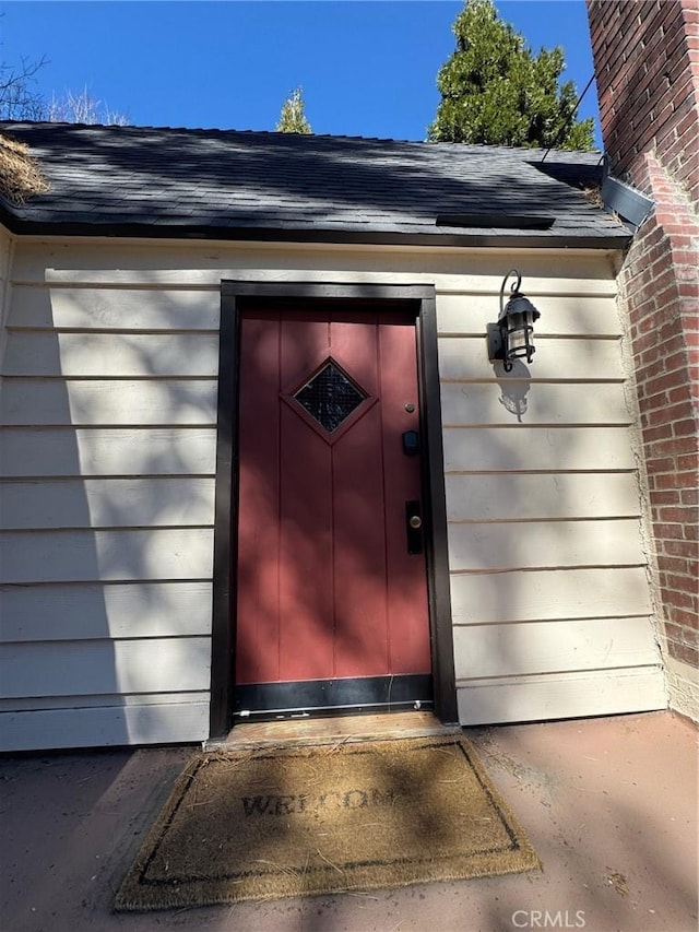 283 Walnut Dr, Lake Arrowhead, CA 92352 - view of exterior entry featuring elevator and roof with shingles