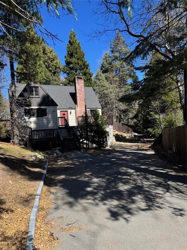 283 Walnut Dr, Lake Arrowhead, CA 92352 - view of front of home with a chimney, a wooden deck, and a shingled roof