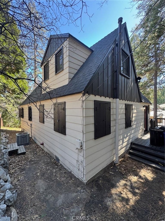 283 Walnut Dr, Lake Arrowhead, CA 92352 - view of side of home with central AC, a deck, a shingled roof, and board and batten siding